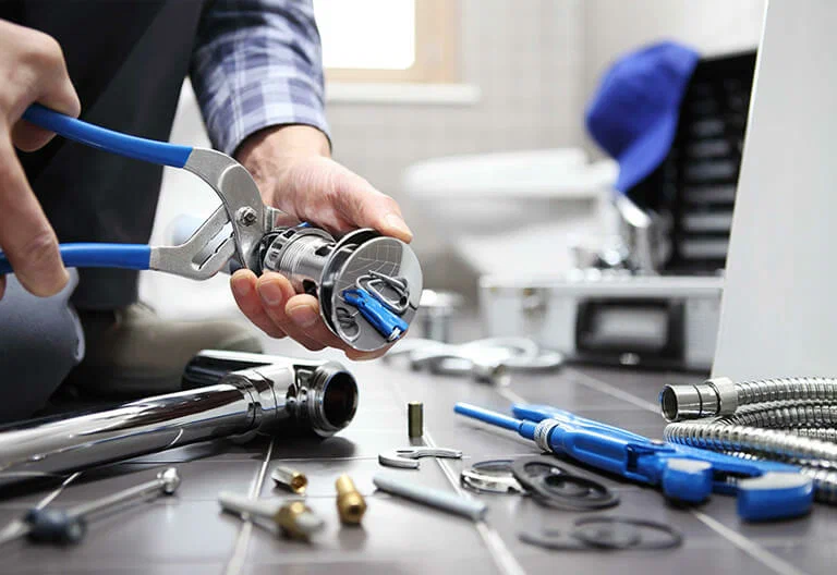 Technician repairing a plumbing fixture with professional tools in Zephyrhills
