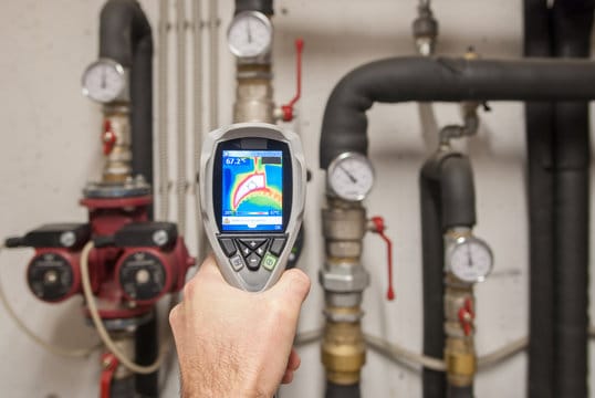 Plumber using a thermal imaging camera to inspect pipes in Zephyrhills