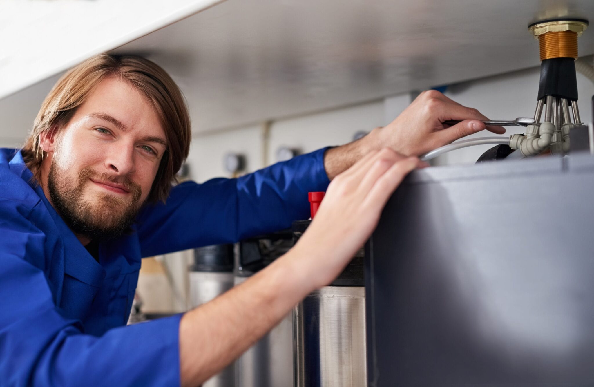 Technician servicing a residential water heater tank in Zephyrhills